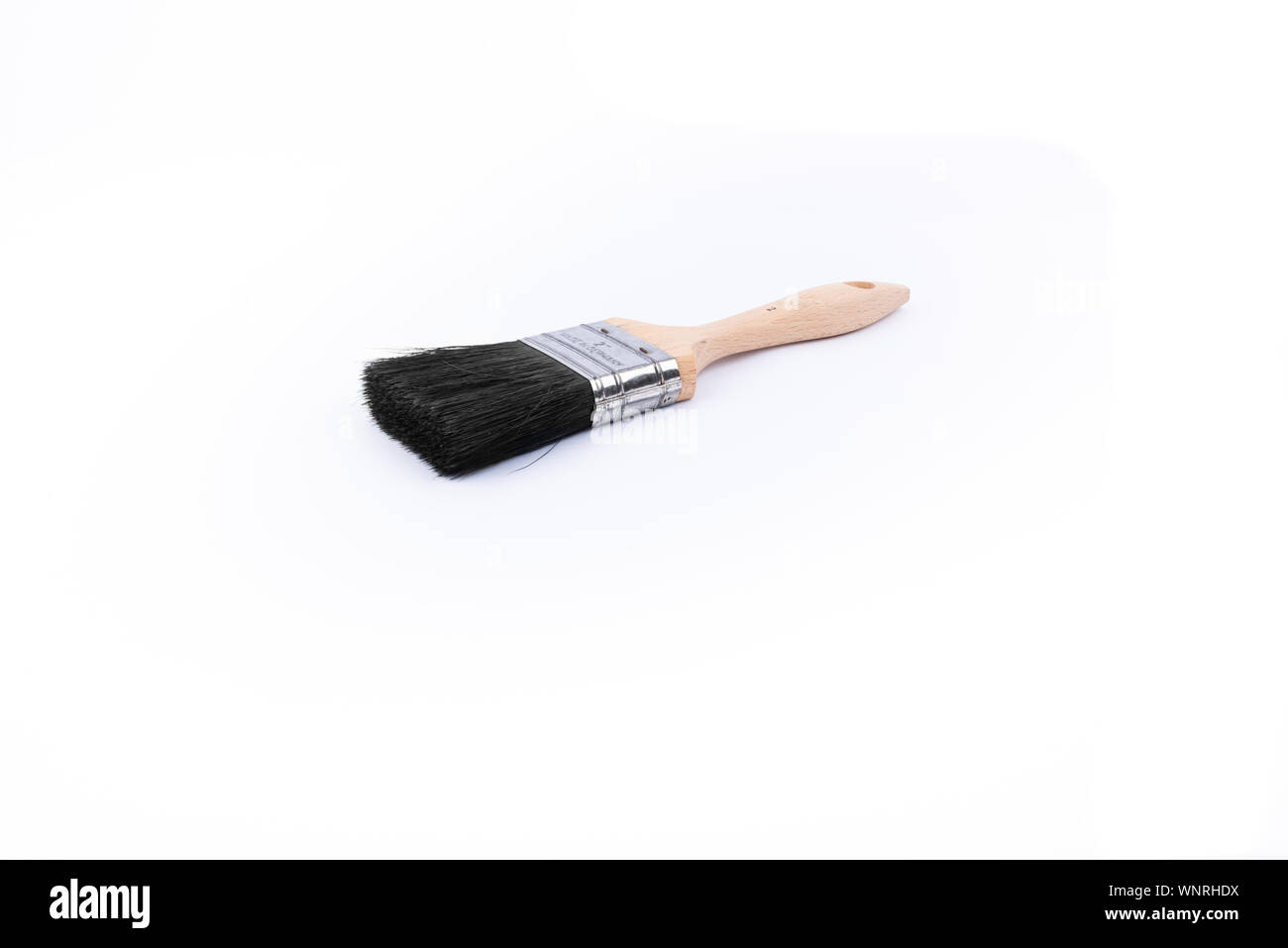 used paintbrush with wooden grip Stock Photo