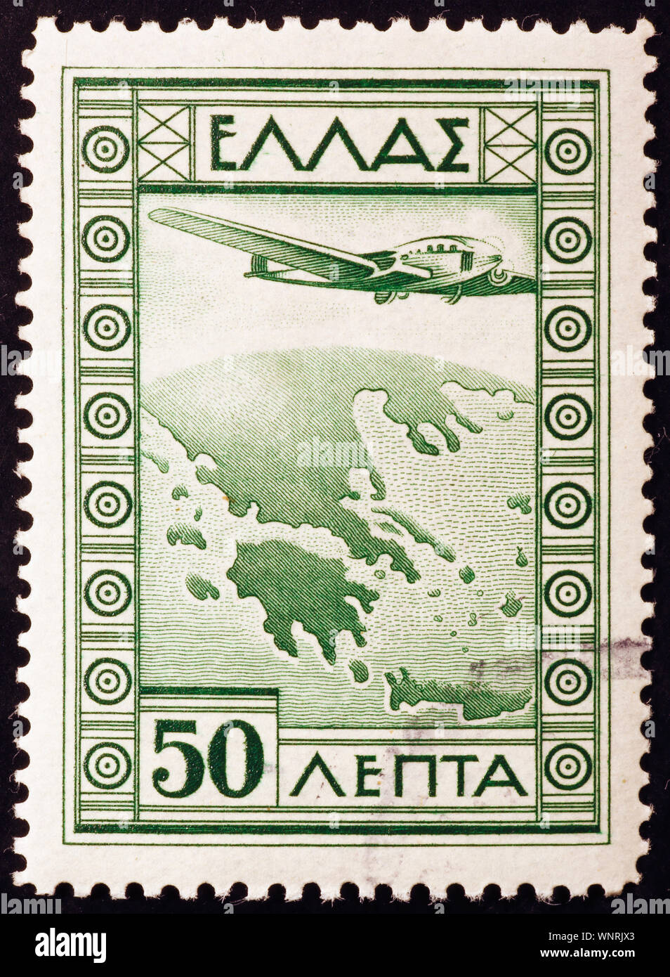 Airplane overflying Greece on vintage postage stamp Stock Photo