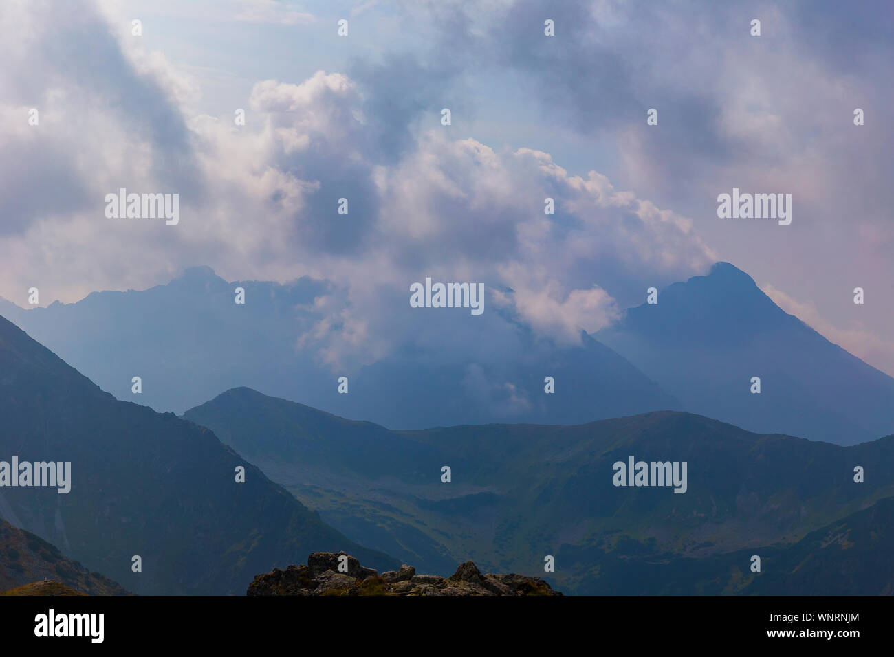 Tatra mountains in the clouds at sunset Stock Photo - Alamy