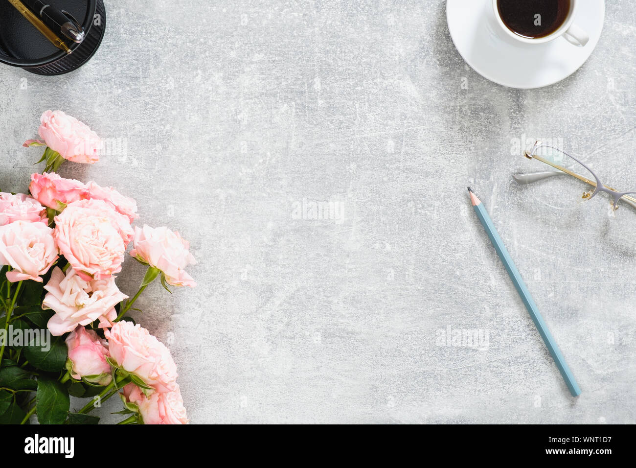 Home Office Desk Workspace With Rose Flowers Coffee Cup Glasses