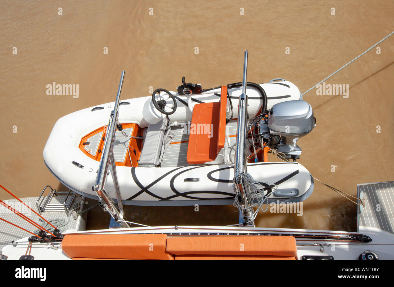 Tender on a dinghy lift/davits system on a catamaran cruising on the