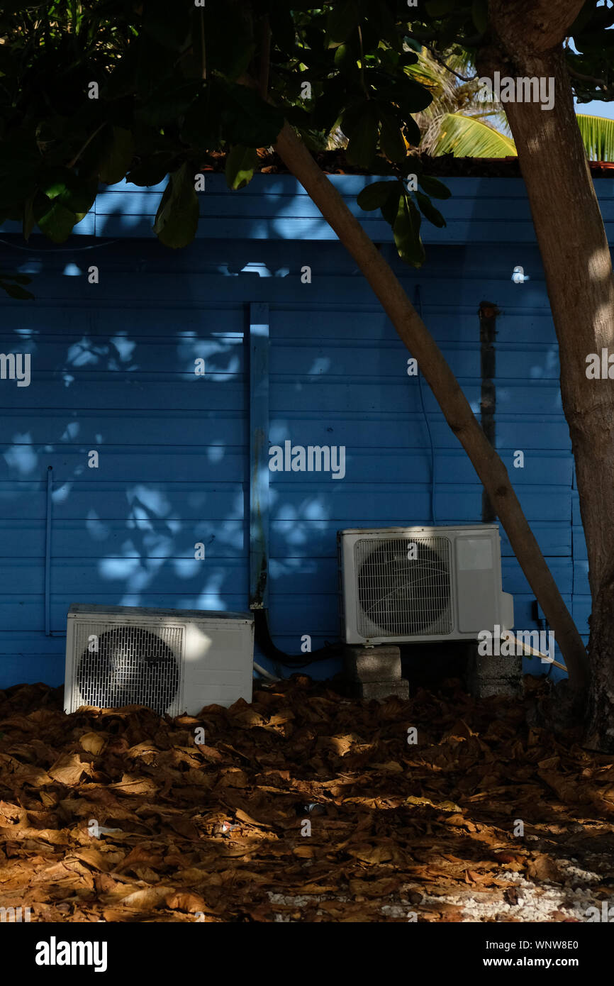 Old air conditioning units behind a house in Bonaire Stock Photo