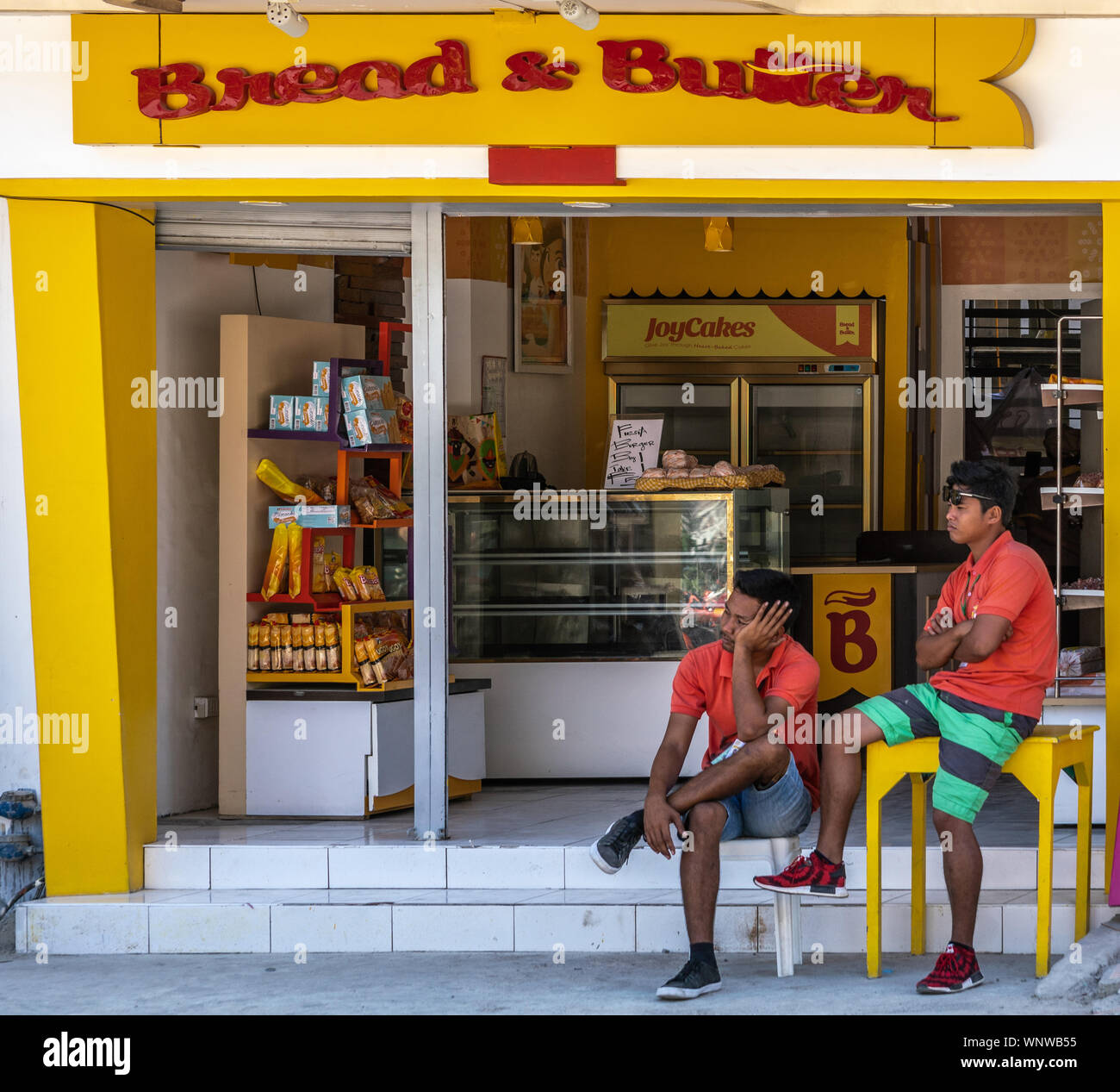 Manoc-Manoc, Boracay Island, Philippines - March 4, 2019: Near Cagban Jetty Port and ferry pier. Bread & Butter bakery shows dominant yellow and white Stock Photo
