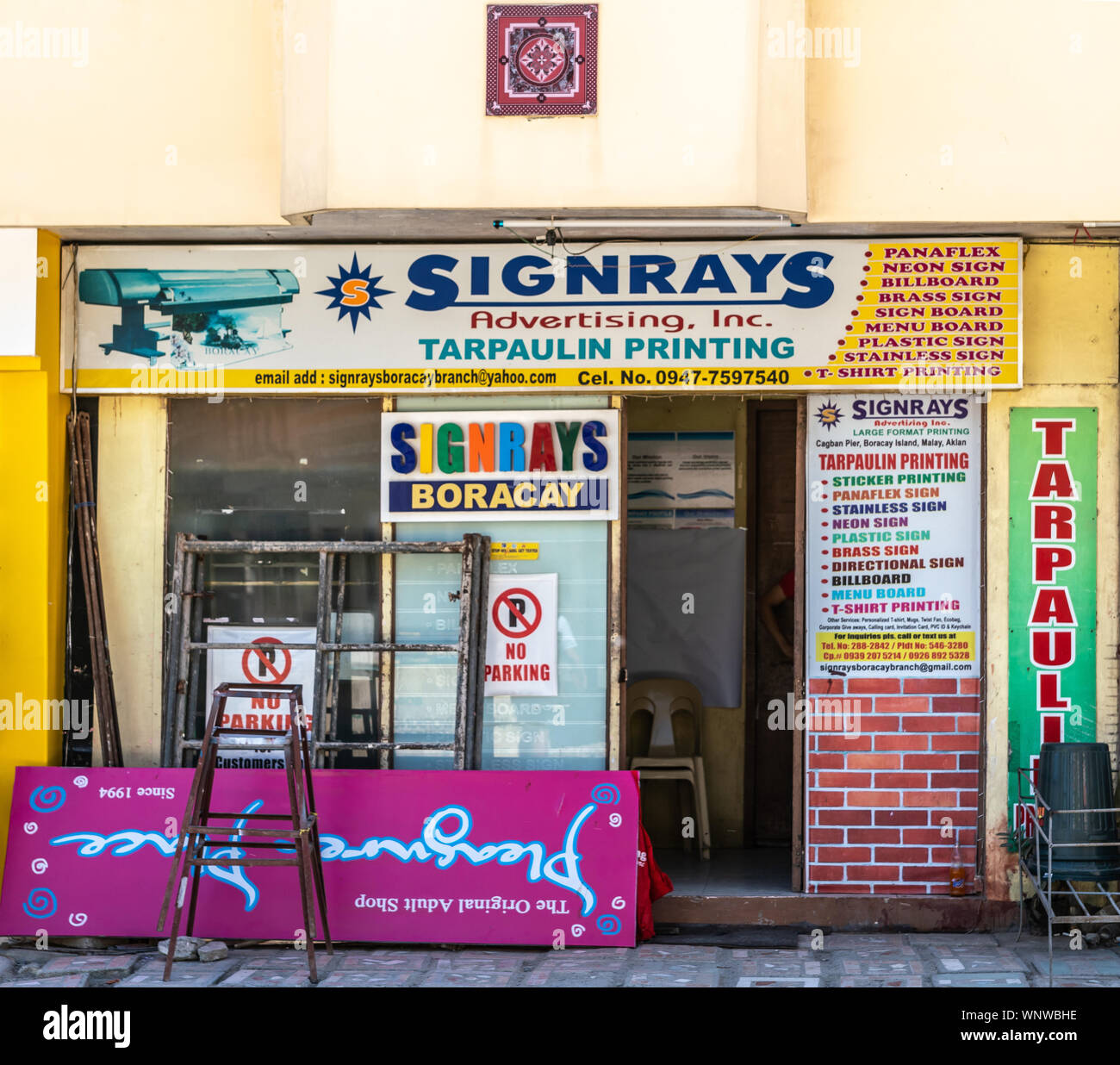 Manoc-Manoc, Boracay Island, Philippines - March 4, 2019: Near Cagban Jetty Port and ferry pier. Signrays advertising office has colorful displays. Stock Photo