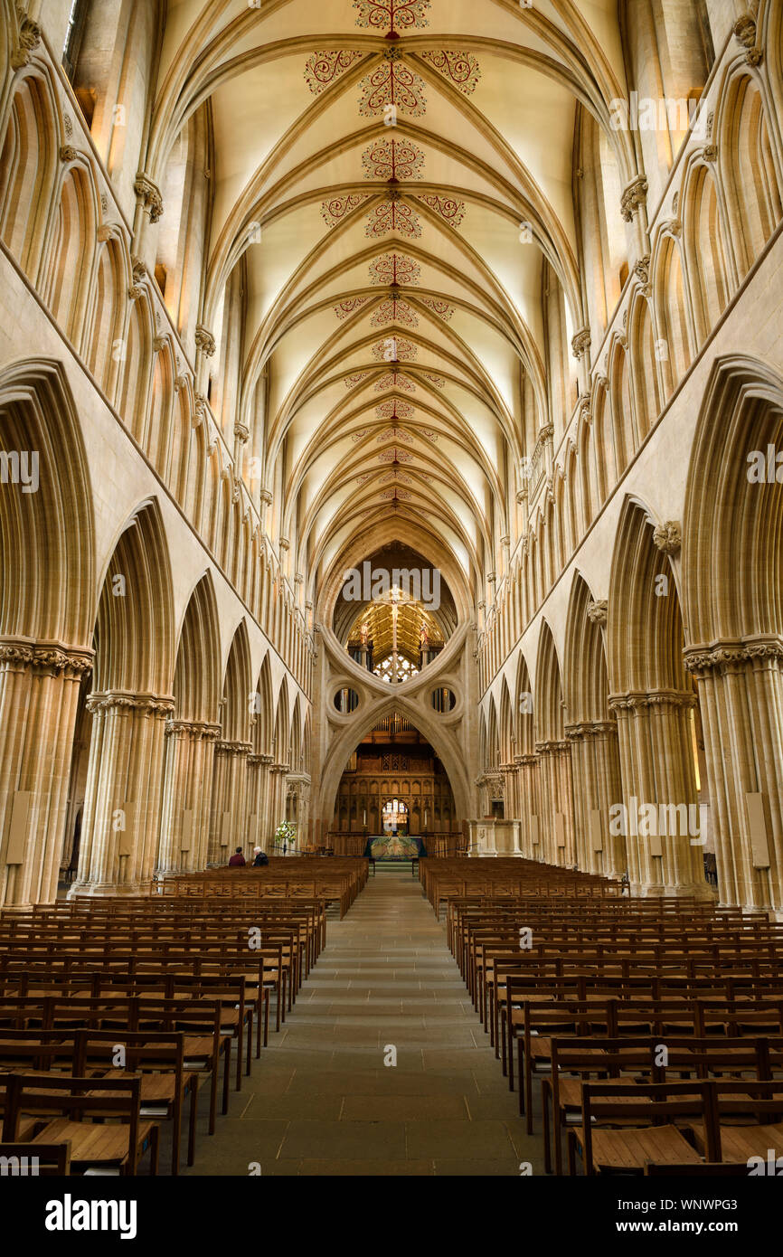 Interior of Wells Cathedral Anglican church with stone pillars leading to St Andrews Cross arches at the sanctuary Wells England Stock Photo