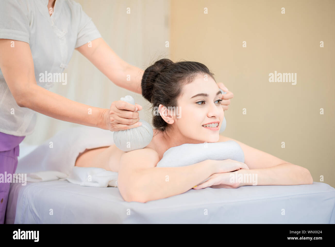 Young healthy asian woman lying relax in spa salon.Traditional Thai oriental aromatherapy and Massage beauty treatments.Recreation vitality wellness w Stock Photo