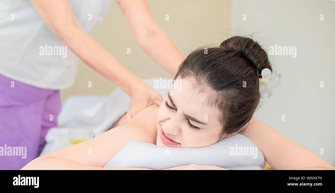 Young healthy asian woman lying relax in spa salon.Traditional Thai oriental aromatherapy and Massage beauty treatments.Recreation vitality wellness w Stock Photo