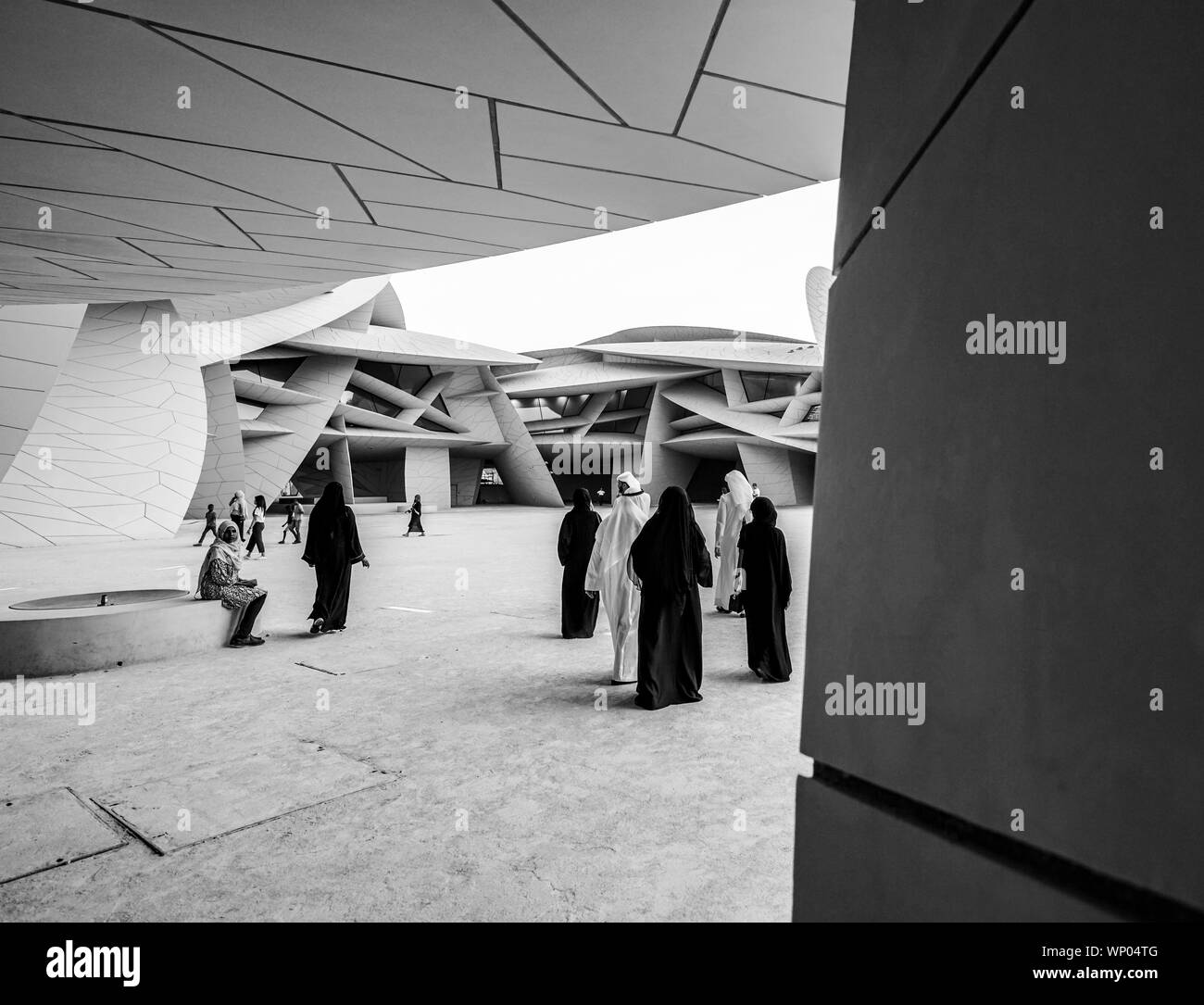 DOHA QATAR - JULY 10 2019; In black and white, people in their ...