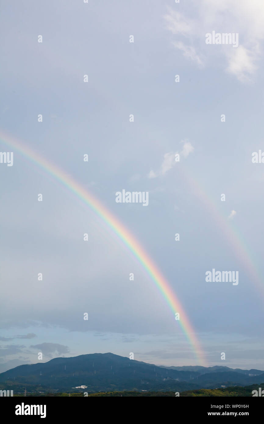 Rainbow, clouds and blue sky Stock Photo - Alamy