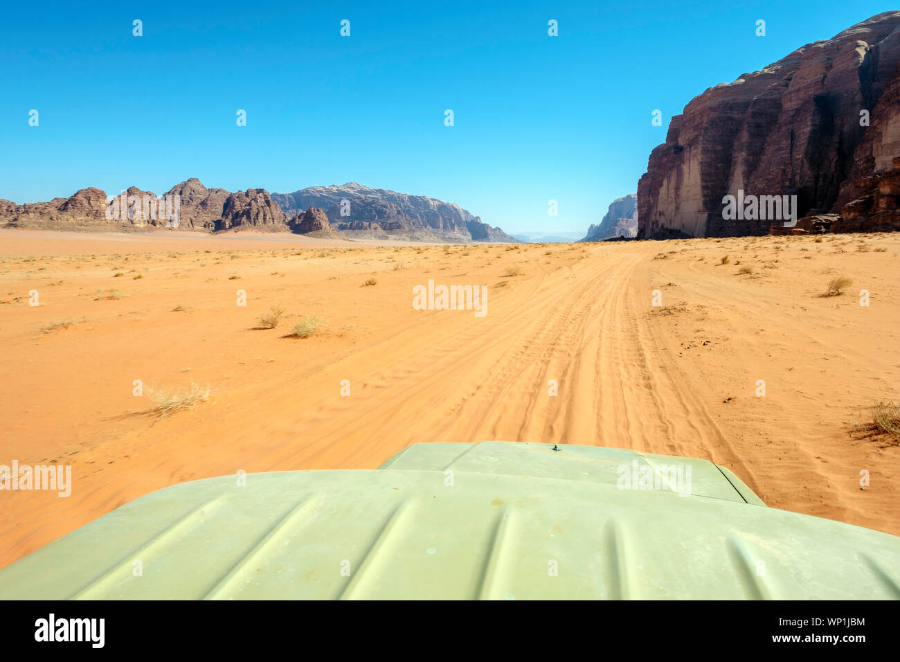 Jordan, Aqaba Governorate, Wadi Rum. Wadi Rum Protected Area, UNESCO World Heritage Site. View from the room of a four wheel drive jeep in desert land Stock Photo