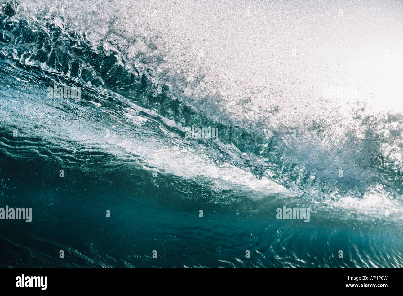 Close up of powerful backlit wave breaking against clear sky Stock Photo