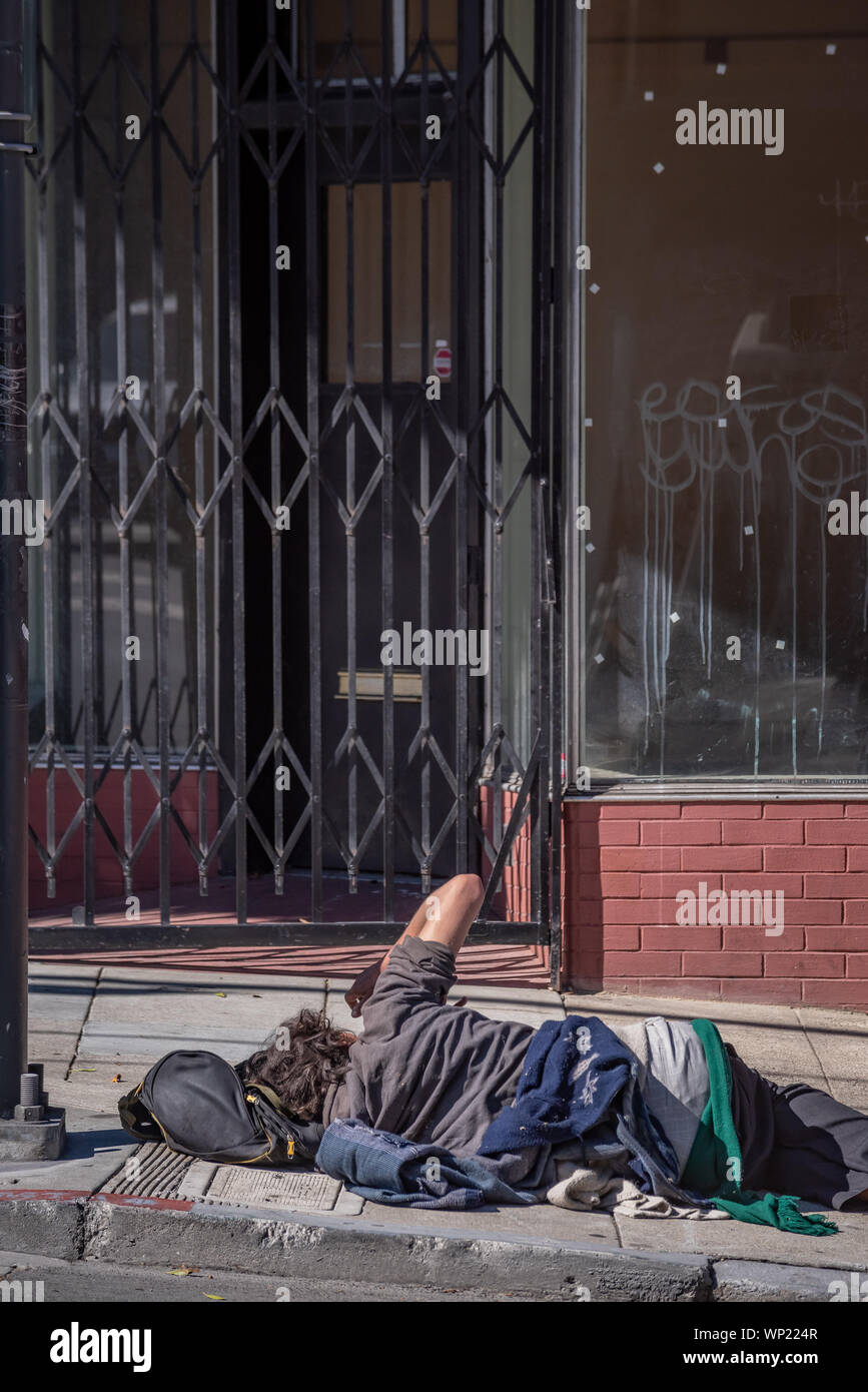 Homeless man sleeping on sidewalk hi-res stock photography and images ...