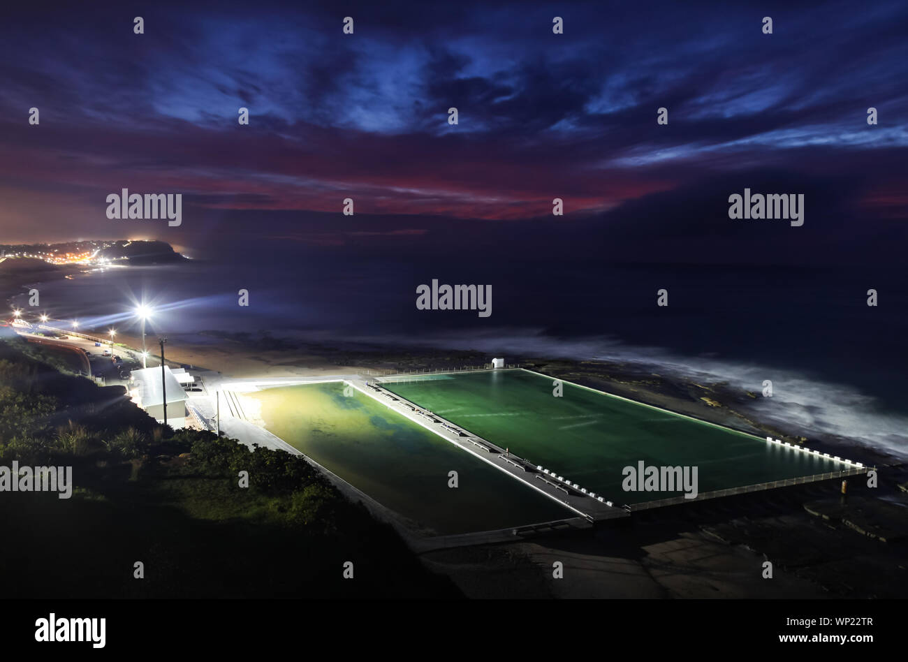 Merewether Ocean baths at dawn from elevated position. These ocean baths are some of the largest in the world and are an iconic landmark in the seasid Stock Photo