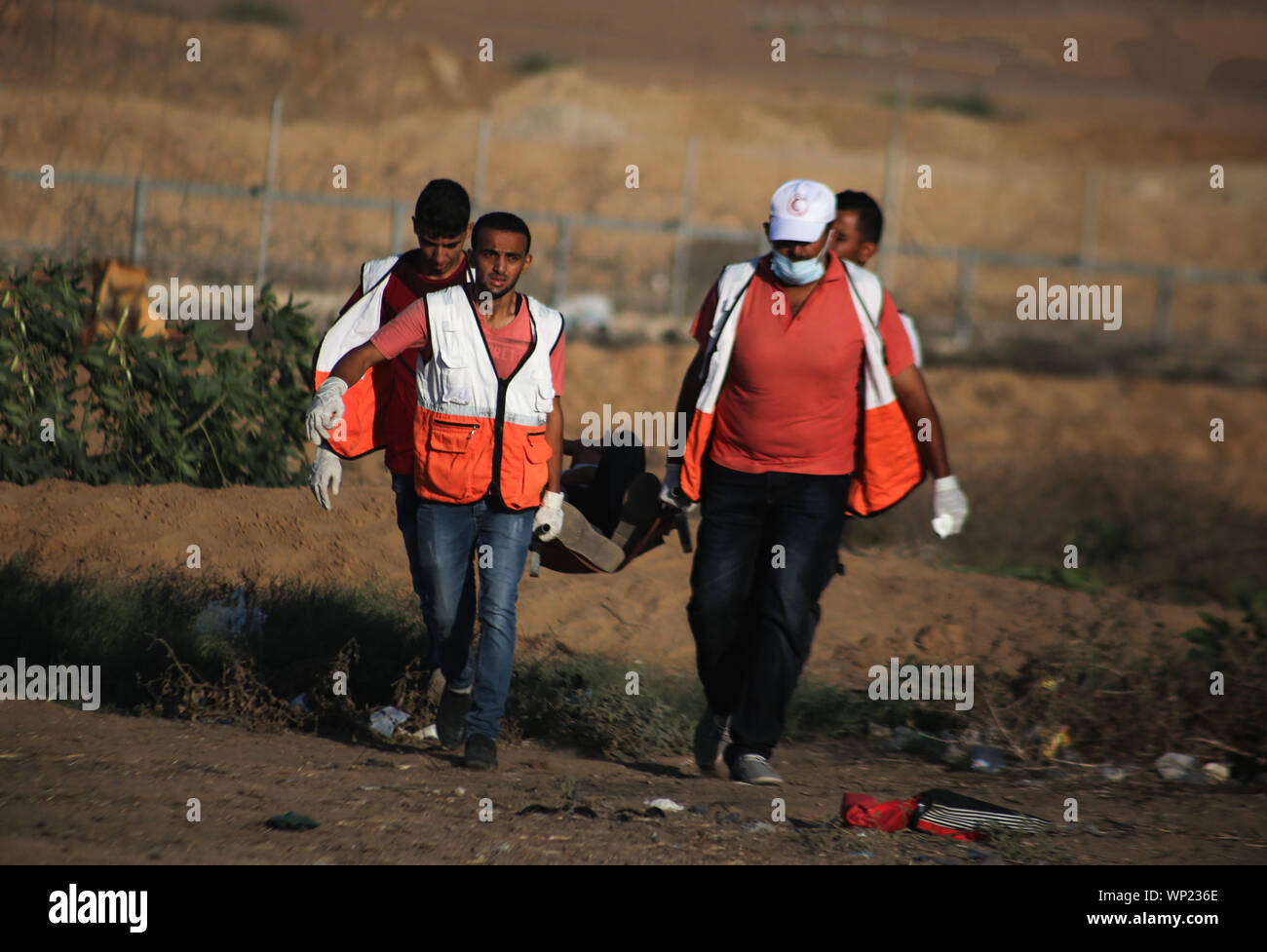 Gaza, Palestine. 06th Sep, 2019. Palestinian medics carry a wounded person during an anti-Israel demonstration at the Israel-Gaza border fence in the southern Gaza Strip. Credit: SOPA Images Limited/Alamy Live News Stock Photo
