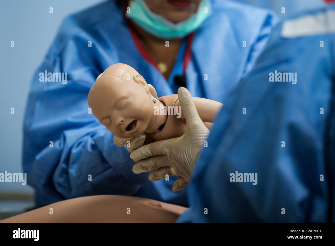 Details with plastic dummies representing a woman and her newly born baby used by medics and midwives for childbirth practice Stock Photo