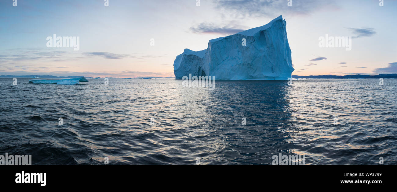 Icebergs in front of the fishing town Ilulissat in Greenland. Nature and landscapes of Greenland. Travel on the vessel among ices. Seascape Stock Photo