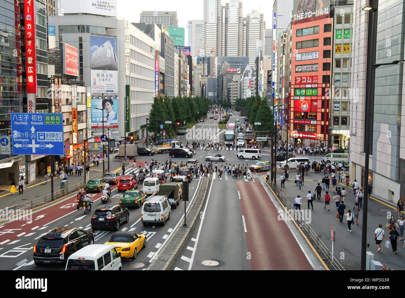 Street scenes with traffic and pedestrian intersection in Shinjuku City in Tokyo Japan Stock Photo