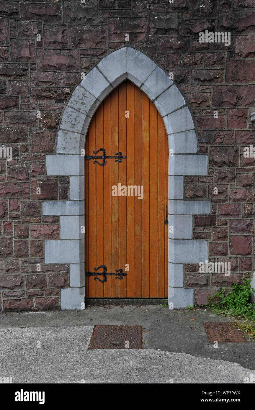 A wooden door in a pointed arch, Tralee, Co Kerry, Ireland. Stock Photo