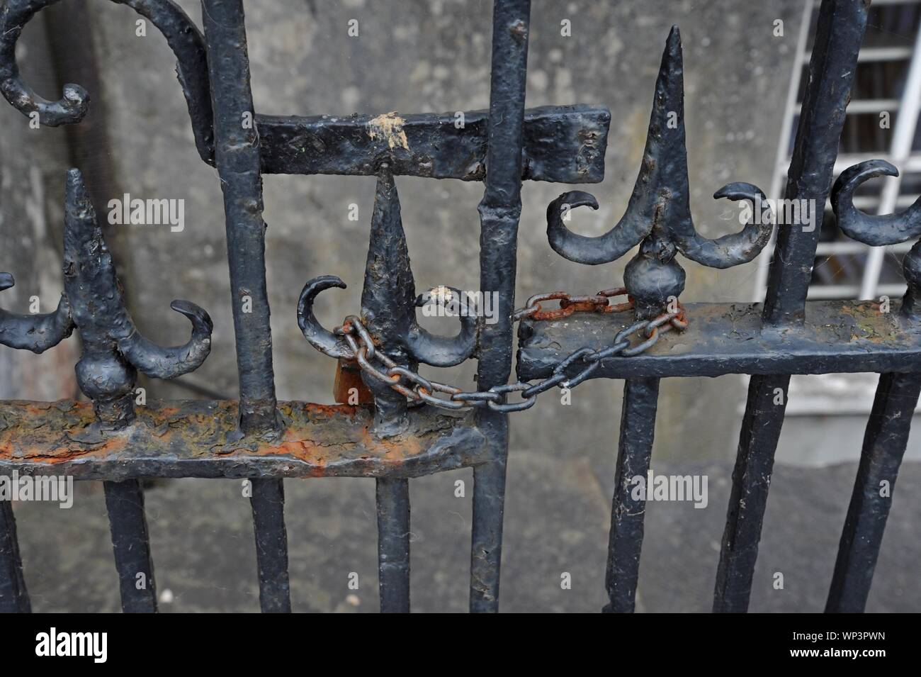 A rusting padlock and chain on a gate and railings in TRalee, CO Kerry Stock Photo
