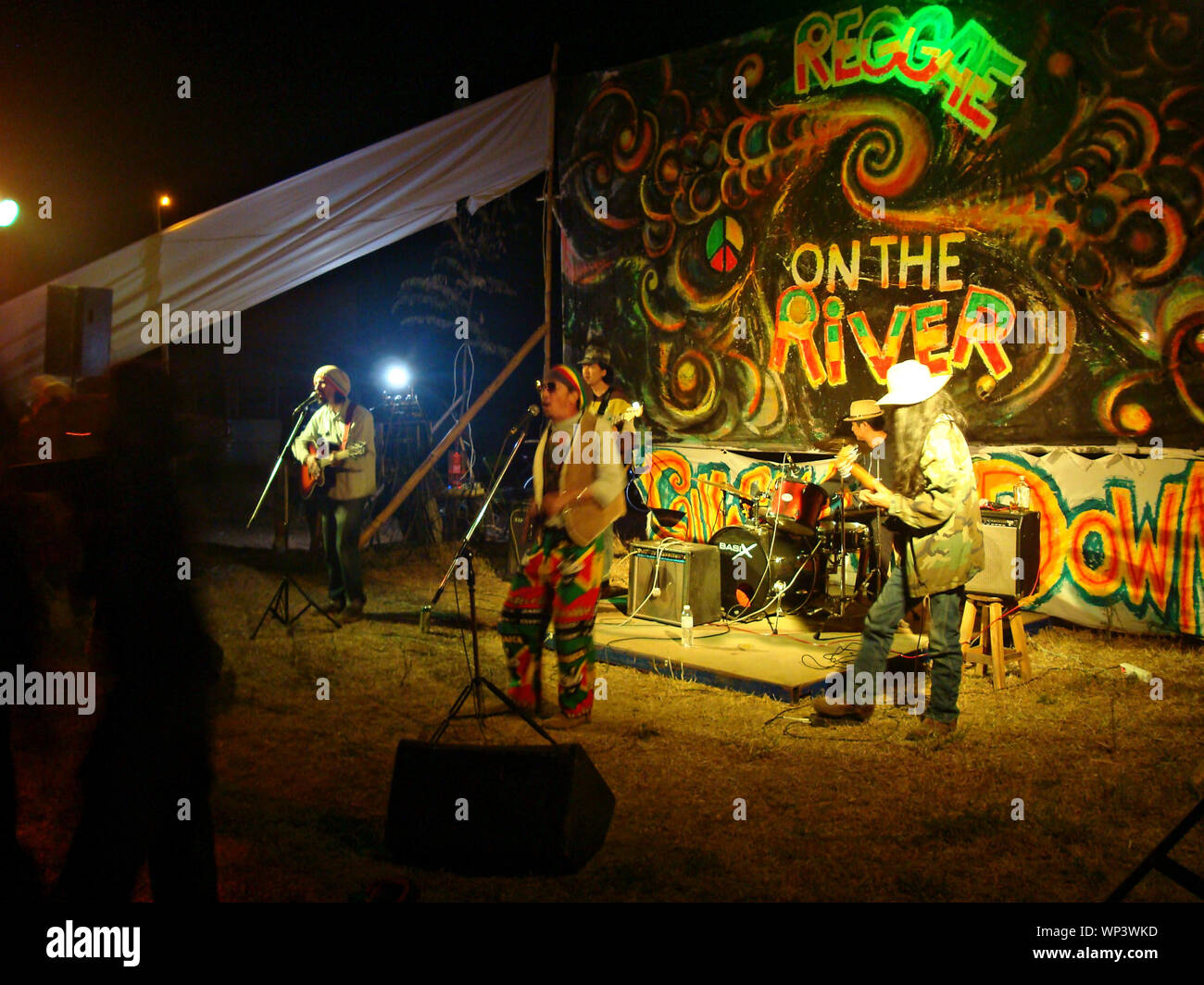 Reggae band concert. On the river. Singers with different instruments