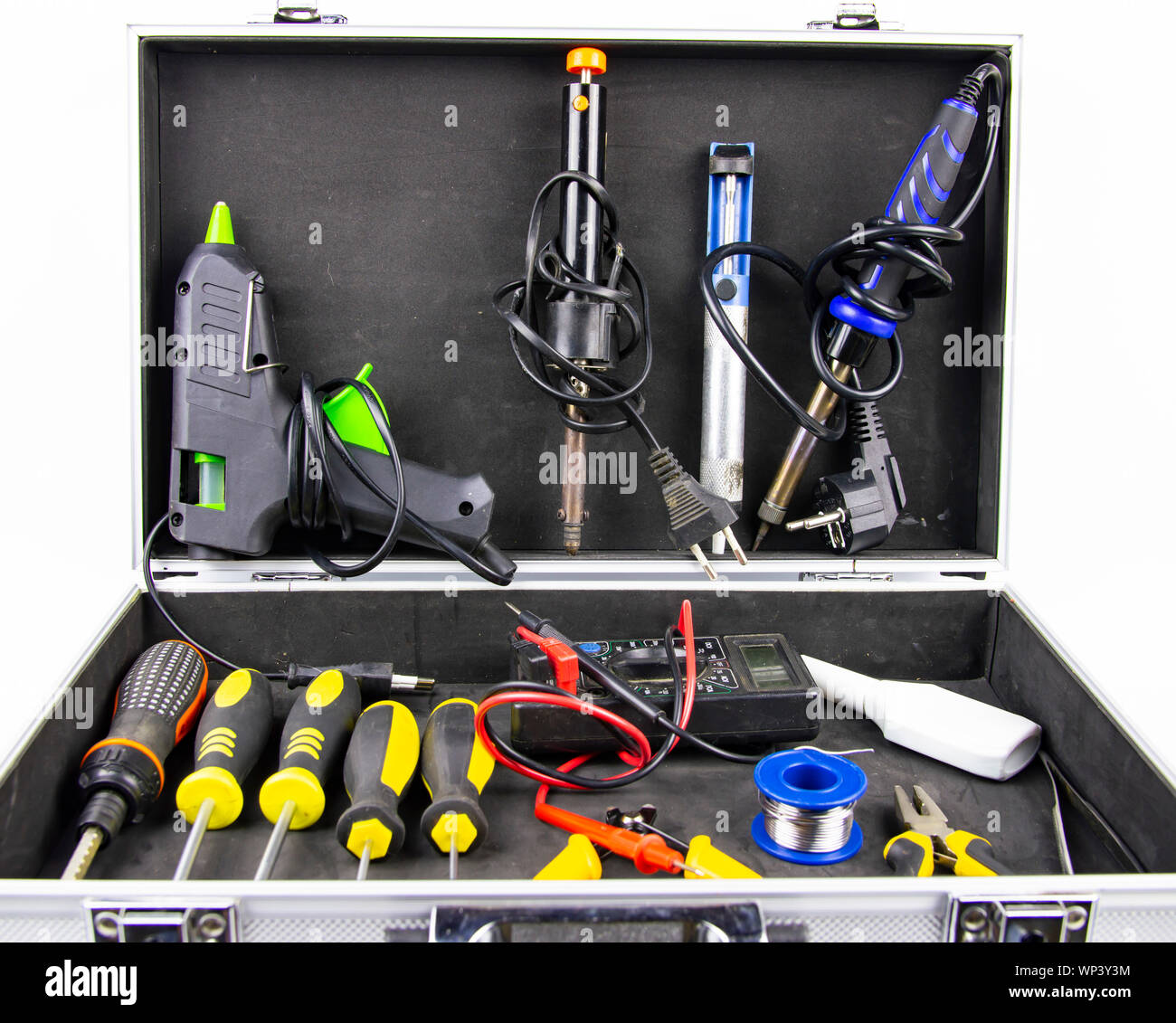 Aluminum case with a working tool on a white background - screwdrivers, pliers, soldering irons. Stock Photo
