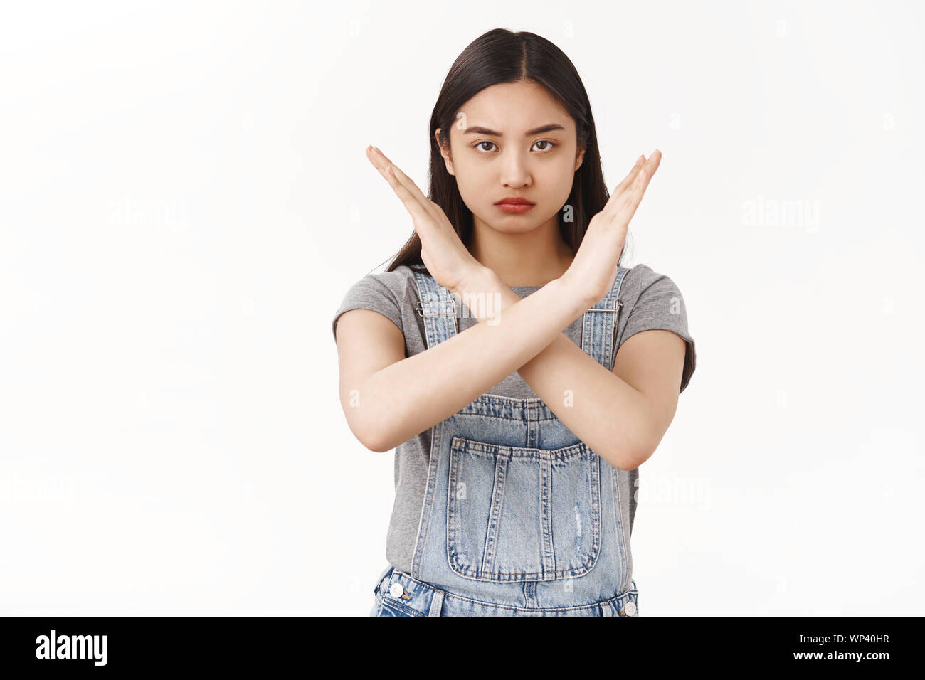 Waist-up serious-looking confident determined asian brunette woman demanding stop show cross arms frowning sulking warn give strong refusal decline hi Stock Photo