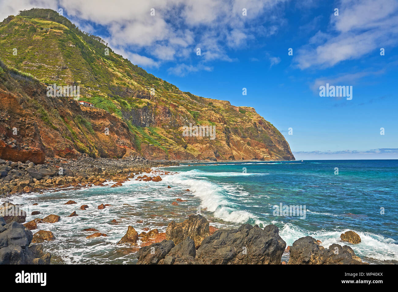 Atlantic Ocean and rugged volcanic coastline of northern Madeira at Porto Moniz, with waves breaking on rocks and shoreline. Stock Photo