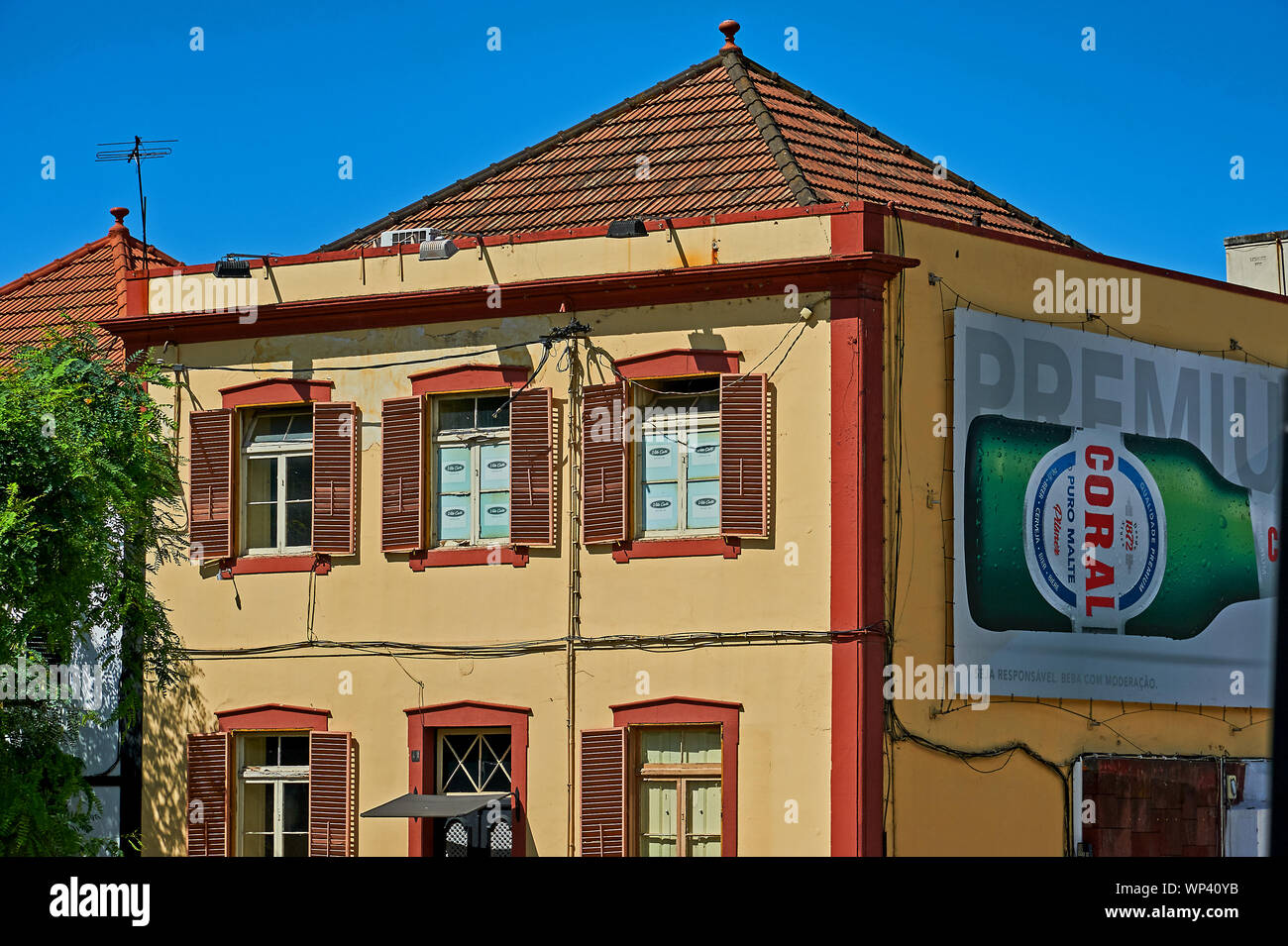 Funchal, Madeira and a large advertising sign for Coral beer on the side of a building. Stock Photo