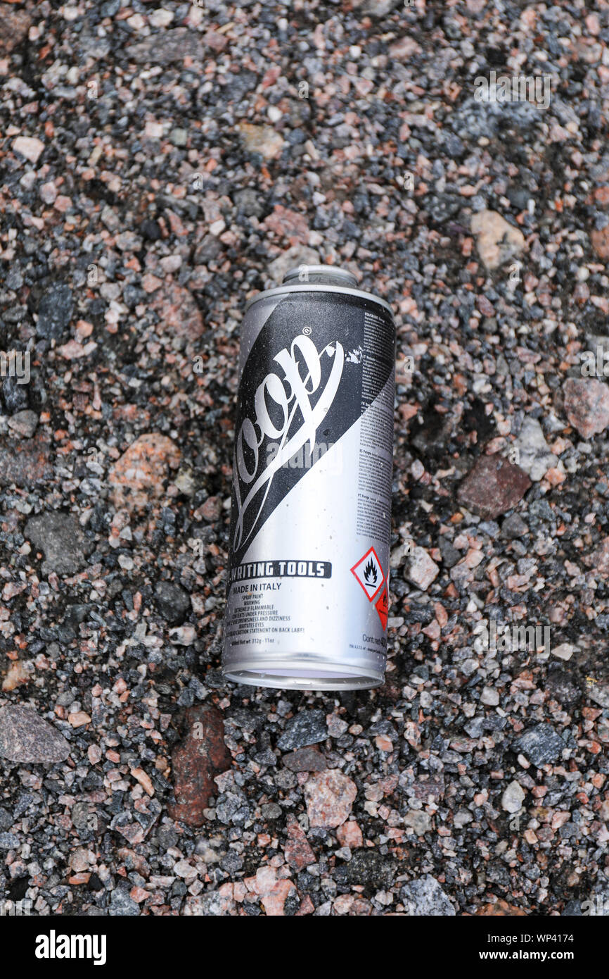 Empty spray paint can left on the ground Stock Photo
