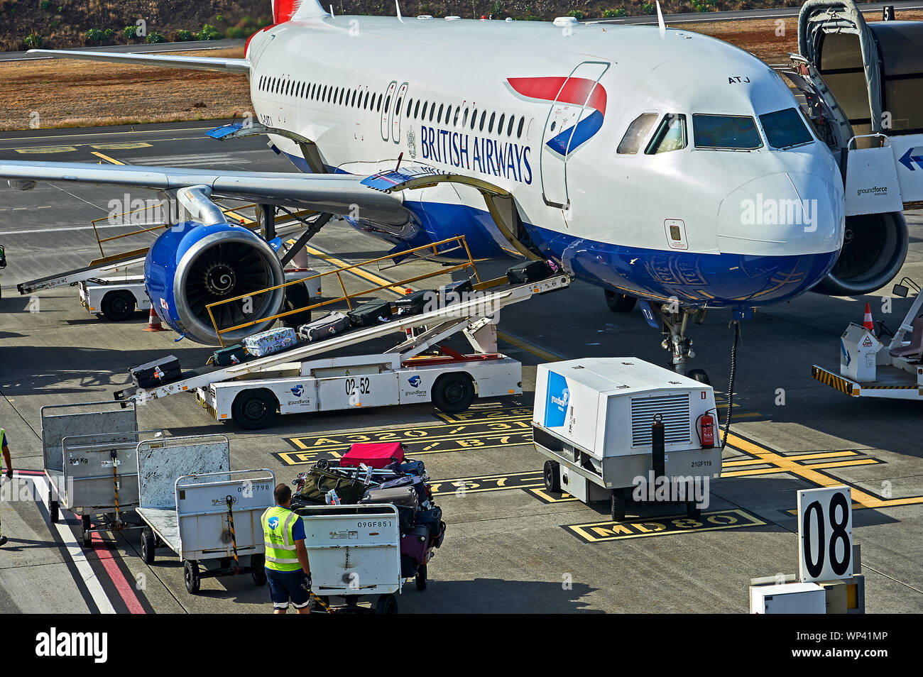 Funchal airport Madeira and a British Airways flight is being prepared for departure, with luggage being loaded into the hold. Stock Photo