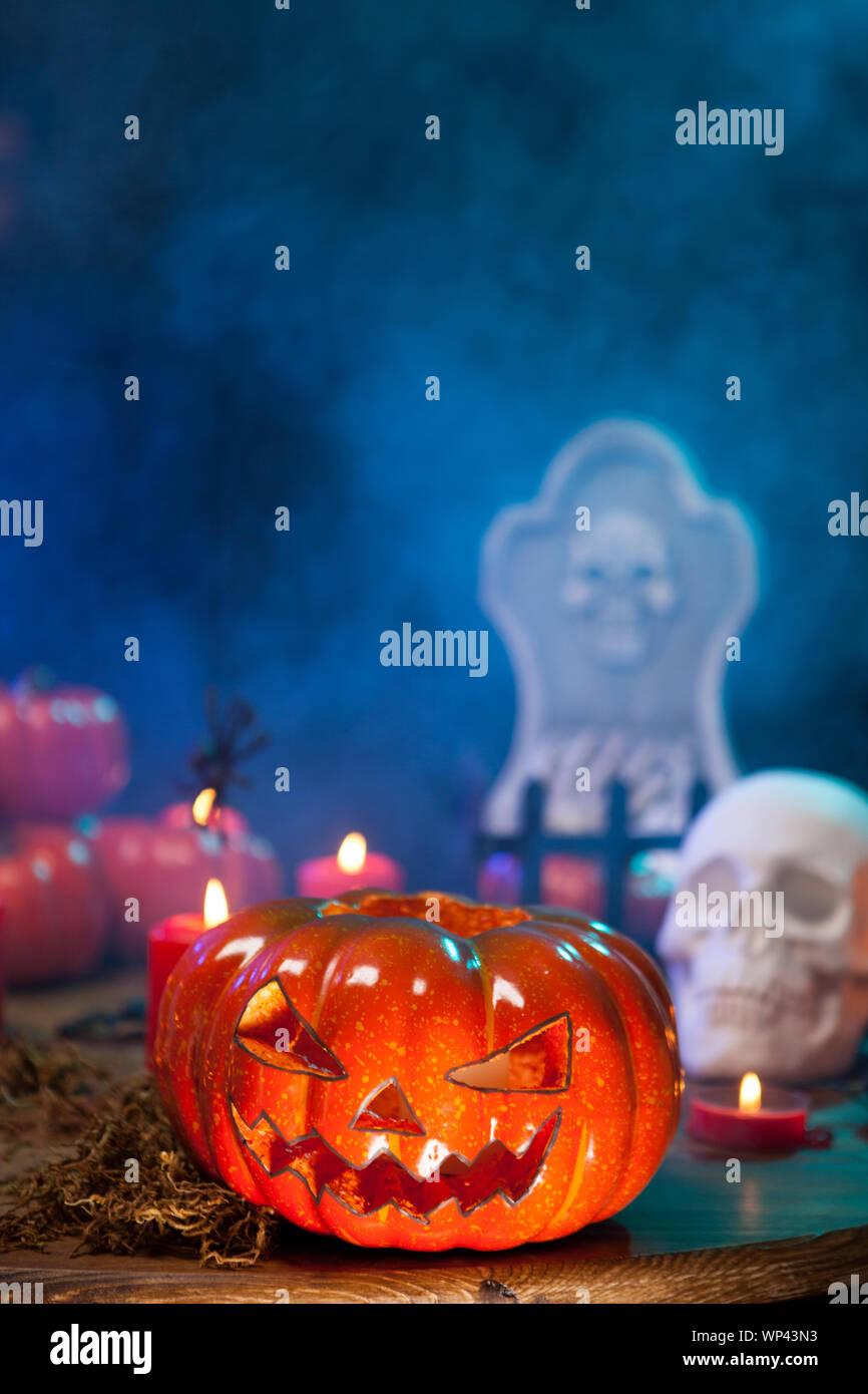 Mysterious mist surrounding a creepy halloween pumpkin on a wooden ...