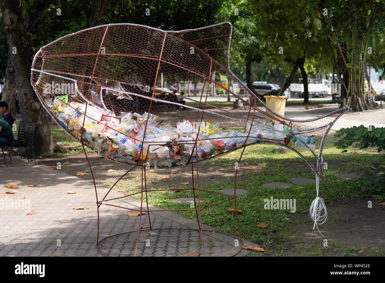 A collection point for used plastic bottles in the form of a metal meshed fish.located in a park within General Santos City,Philippines. Stock Photo