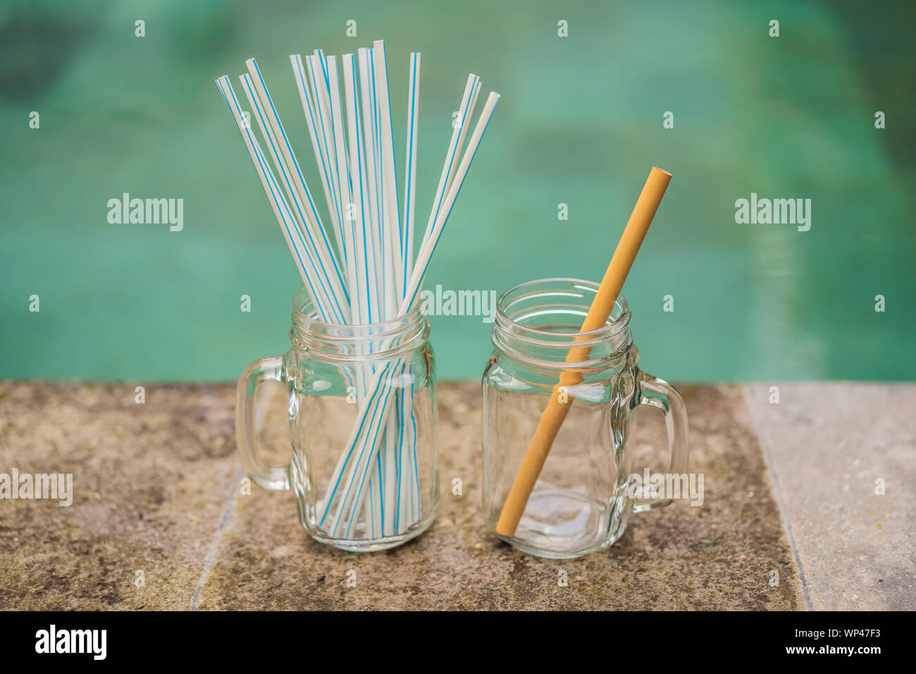 Bamboo drinking straw vs disposable straws on the background of the