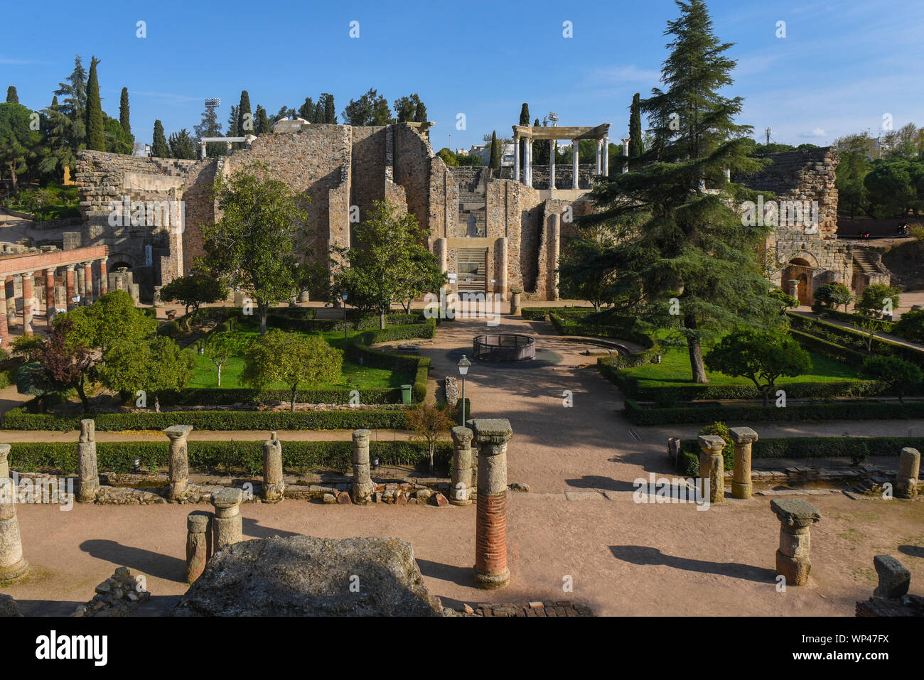 View of the Roman ruins of Merida, Spain, looking from the gardens towards the theatre.  Columns and green trees Stock Photo