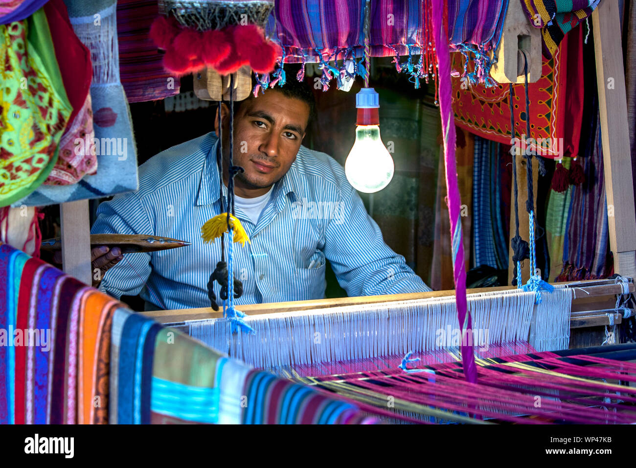 A man operating a weaving loom in the Nubian village of GarbSohel in