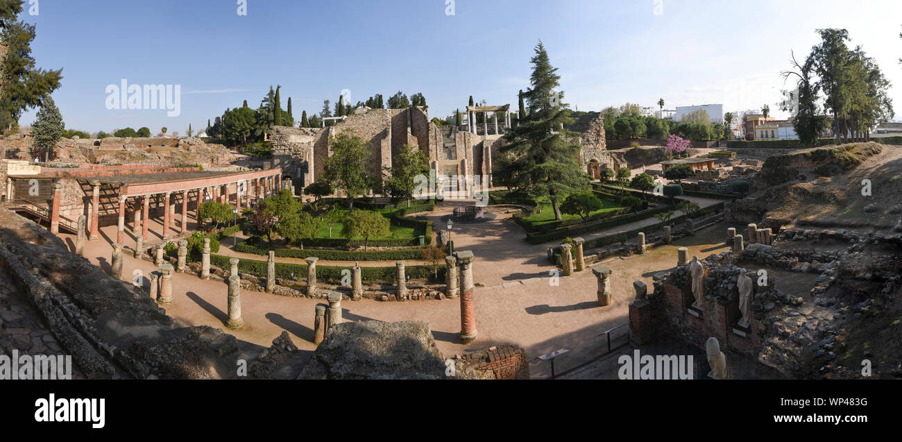 Wide panoramic view of the Roman ruins of Merida, Spain, looking from the gardens towards the theatre.  Columns and green trees Stock Photo