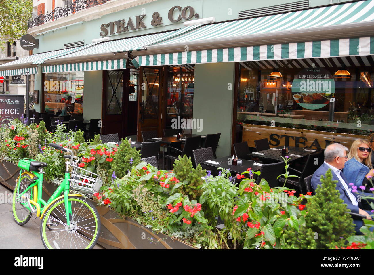 Diners sitting in the outside area of the Steak & Co restaurant near Leicester Square, London, UK Stock Photo