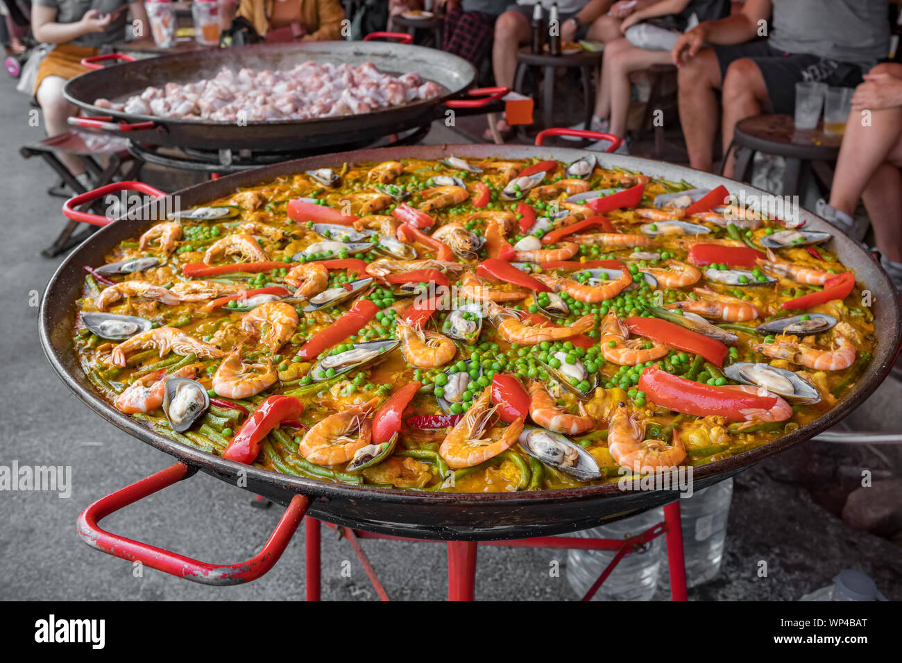 Big wok pan of spanish seafood paella with mussels, shrimps and vegetables  Stock Photo - Alamy