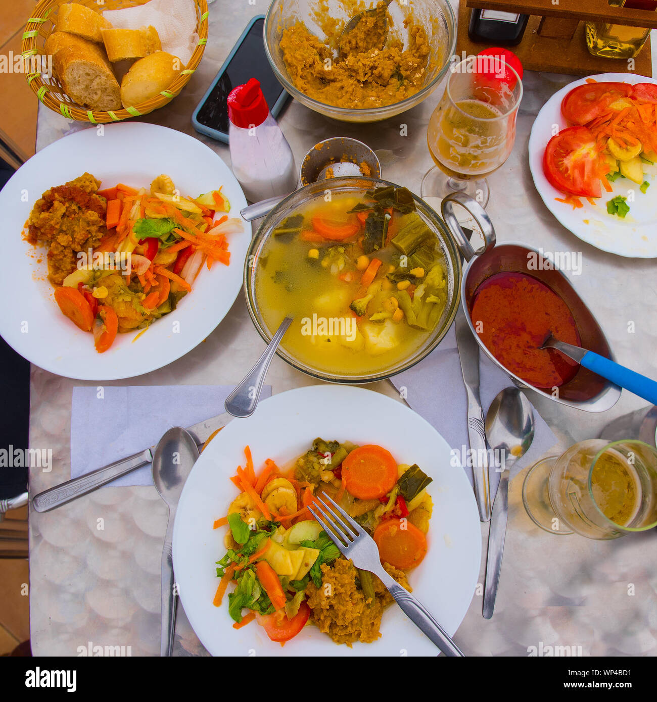 Typical Gomeran food Puchero de verduras (vegetble stew), gofio (toasted maize flour), almogrote (goat's cheese and paprika), salad, mojo (red canaria Stock Photo