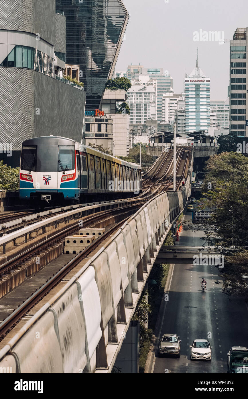 BTS skytrain is running over the busy road in Bangkok, Thailand Stock Photo