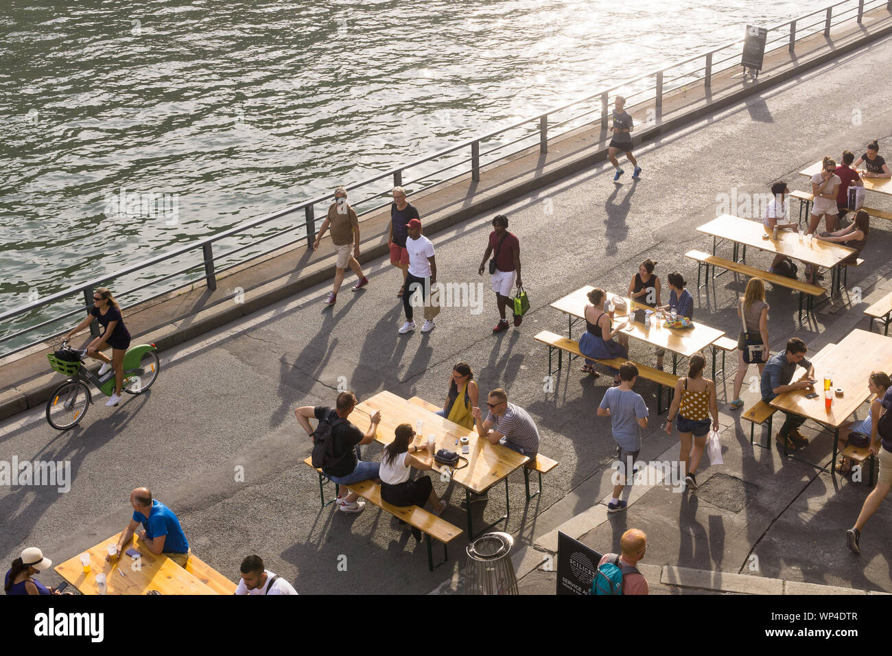 Paris riverbank - people enjoying summer on the Seine riverbank in the 1st arrondissement of Paris, France, Europe. Stock Photo