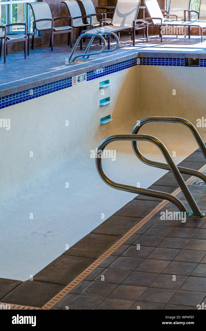 Empty Hotel Pool with Tile and Chairs Stock Photo