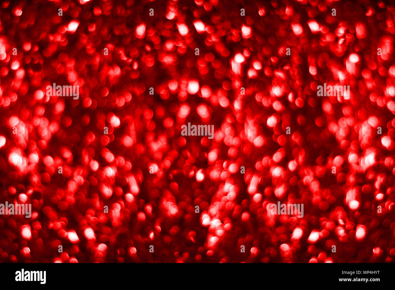 Red Glitter Background. Blur Backdrop with stars in blurred lights