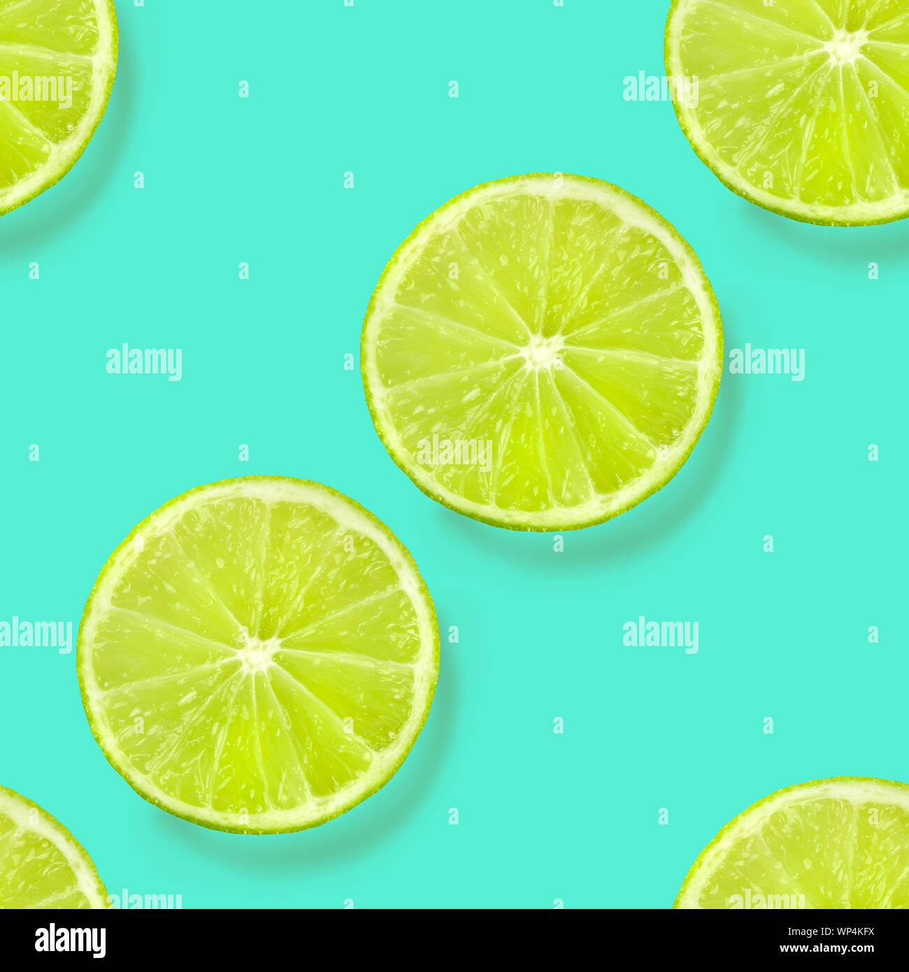 A seamless limes pattern on a vibrant teal blue background, a fruity citrus repeat print Stock Photo