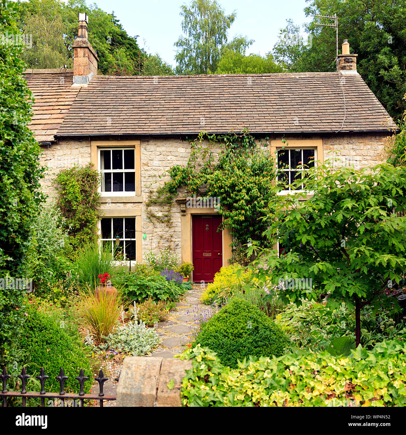 Attractive stone cottage and country garden in Tideswell  Derbyshire Dales UK Stock Photo