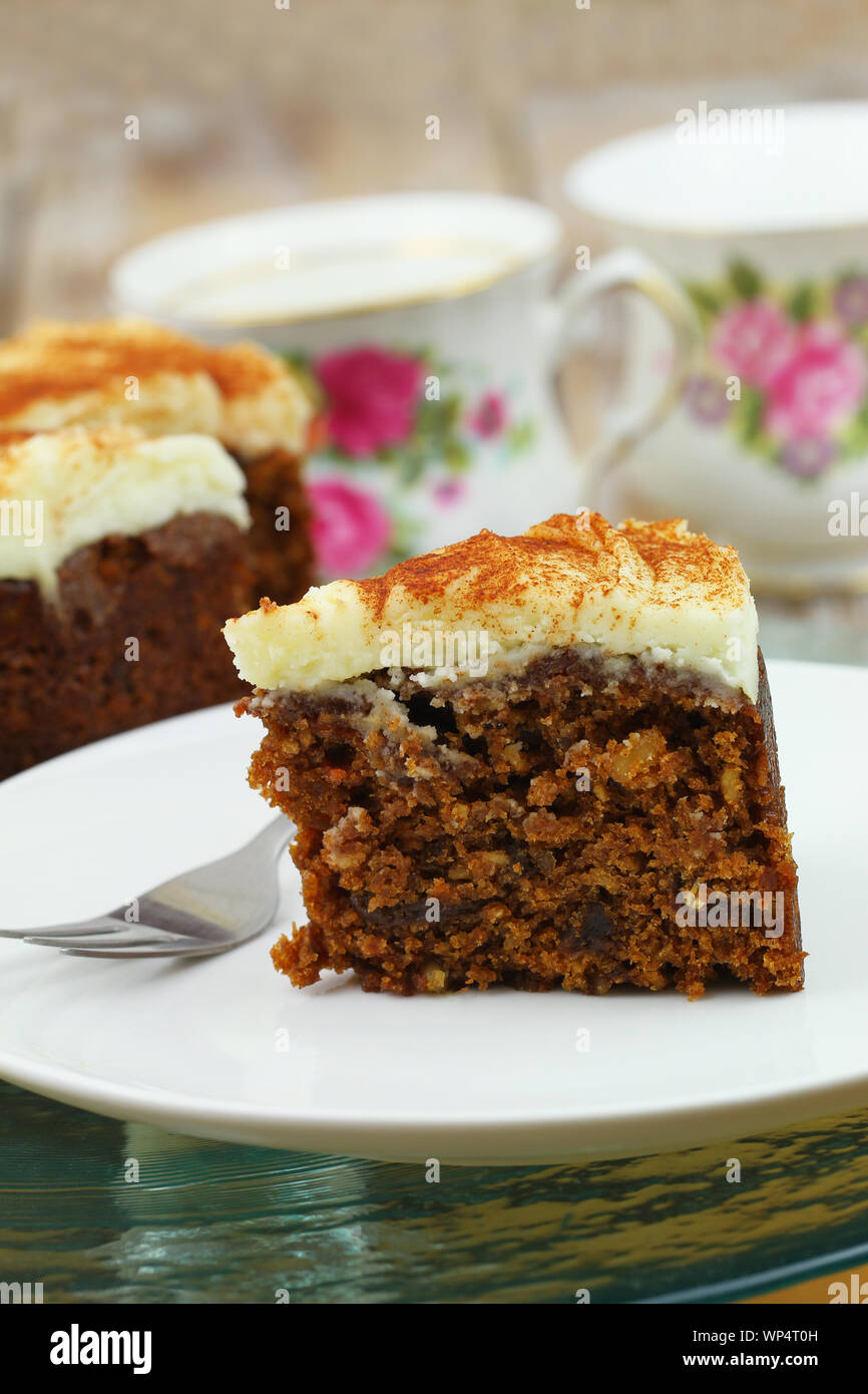 Delicious walnut and carrot cake with marzipan icing on white plate, closeup Stock Photo