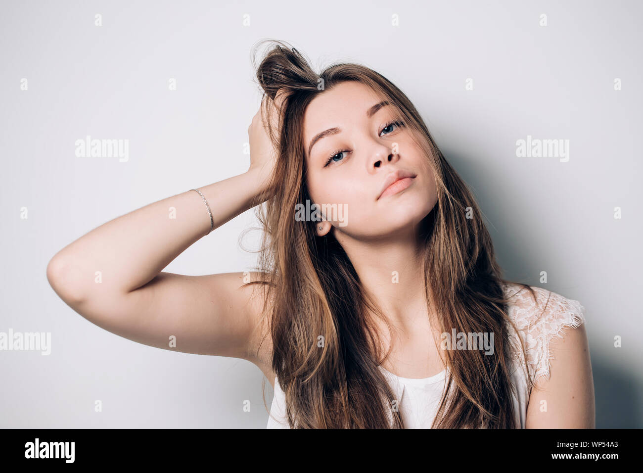 Beautiful portrait of young brunette woman with long hair on white ...