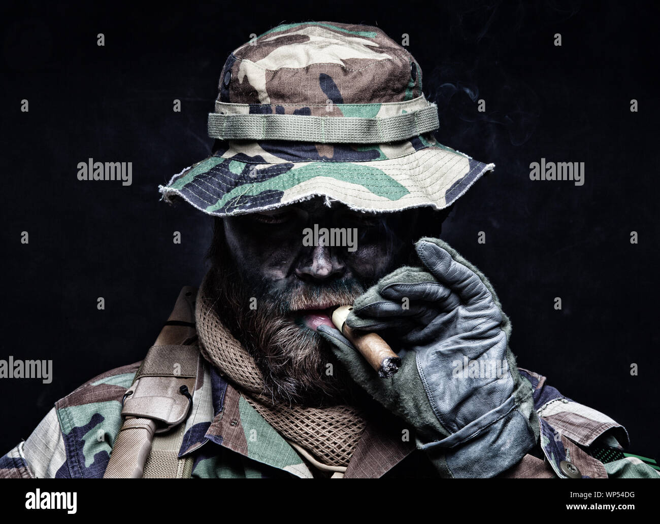 Commando soldier in boonie hat smoking cigar Stock Photo Alamy
