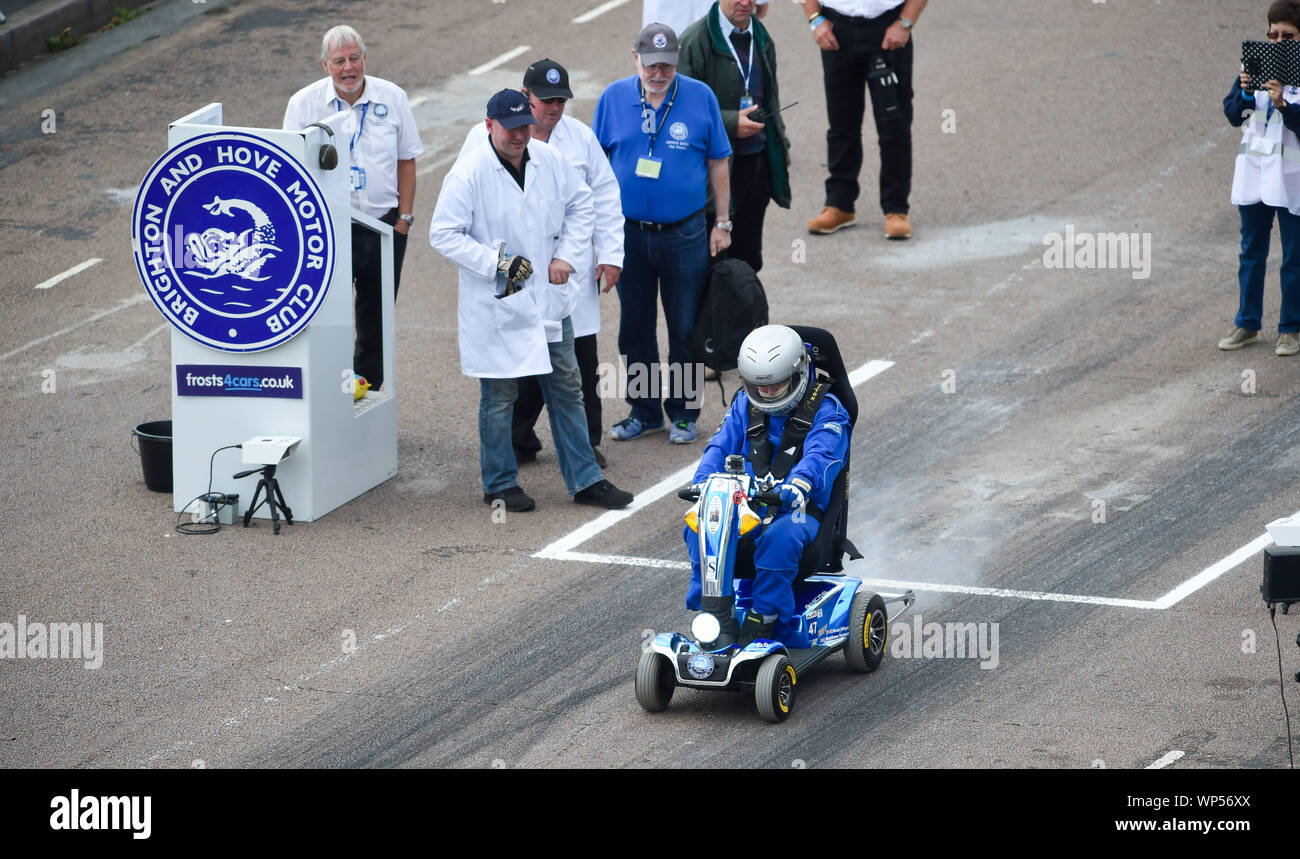 Brighton UK 7th September 2019 - Noel Wilson who has MS takes part on his mobility scooter raising money for the MS Society in the annual Brighton National Speed Trials along Madeira Drive on the seafront . The event is run by the Brighton and Hove Motor Club and is open to cars and motorcycles old and new with some of the drivers in their eighties as well . Credit : Simon Dack / Alamy Live News Stock Photo