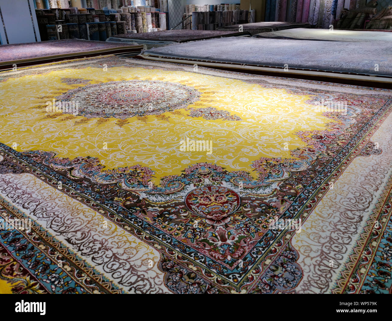 Multicolored persian carpets or rugs or floor mats at display ina shop Stock Photo Alamy